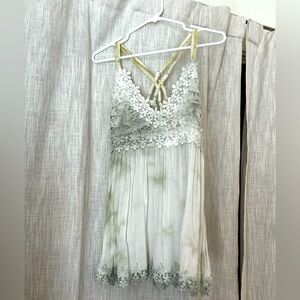 Super cute light green tank top with a criss cross back.